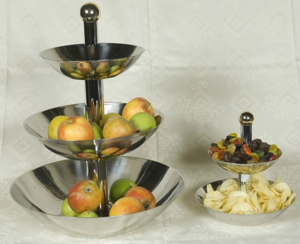 Eight shirts arranged on table in black, olive, grey, blue, white, red, mustard, and green.
