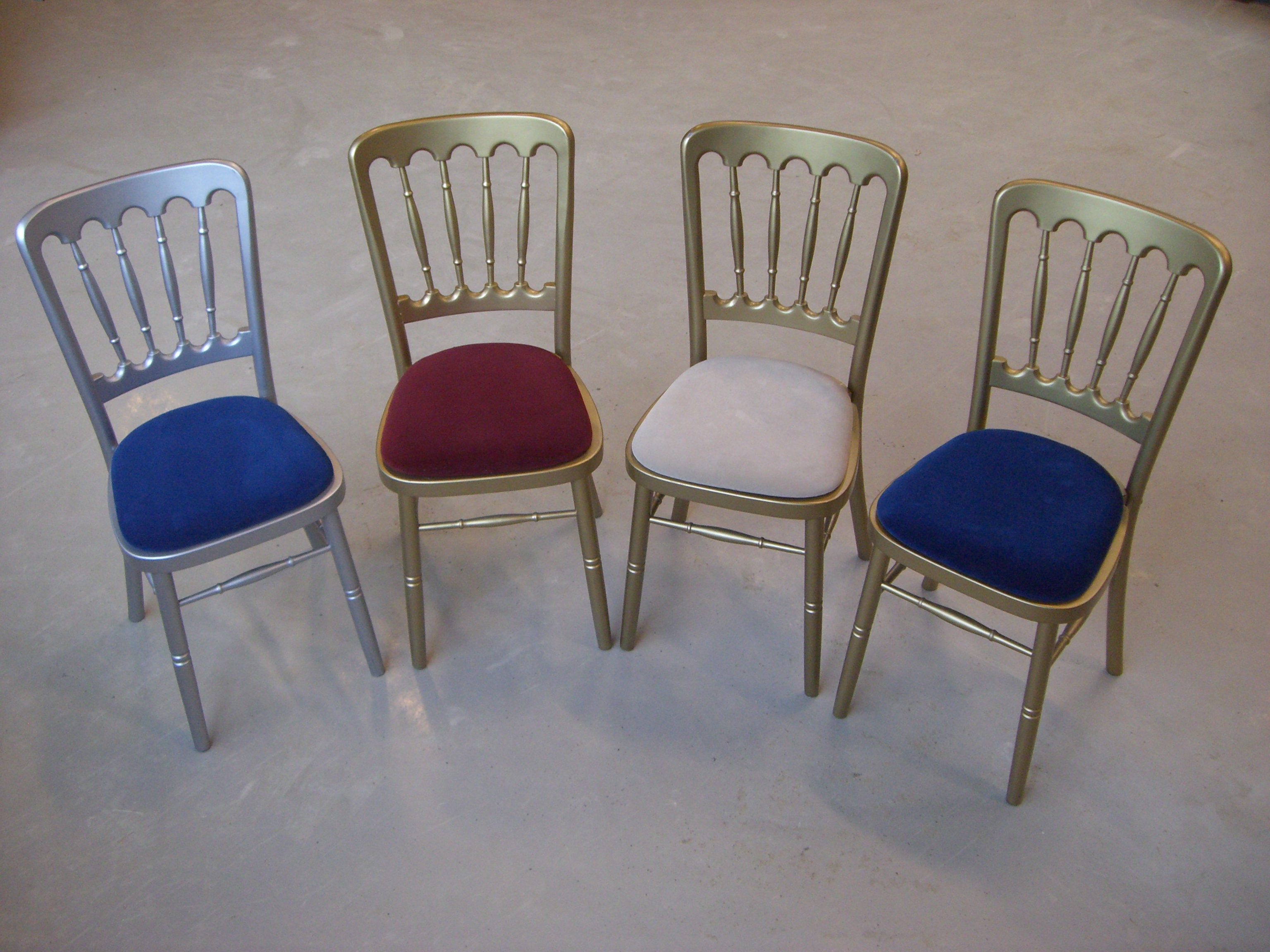 Eight shirts arranged on table in black, olive, grey, blue, white, red, mustard, and green.